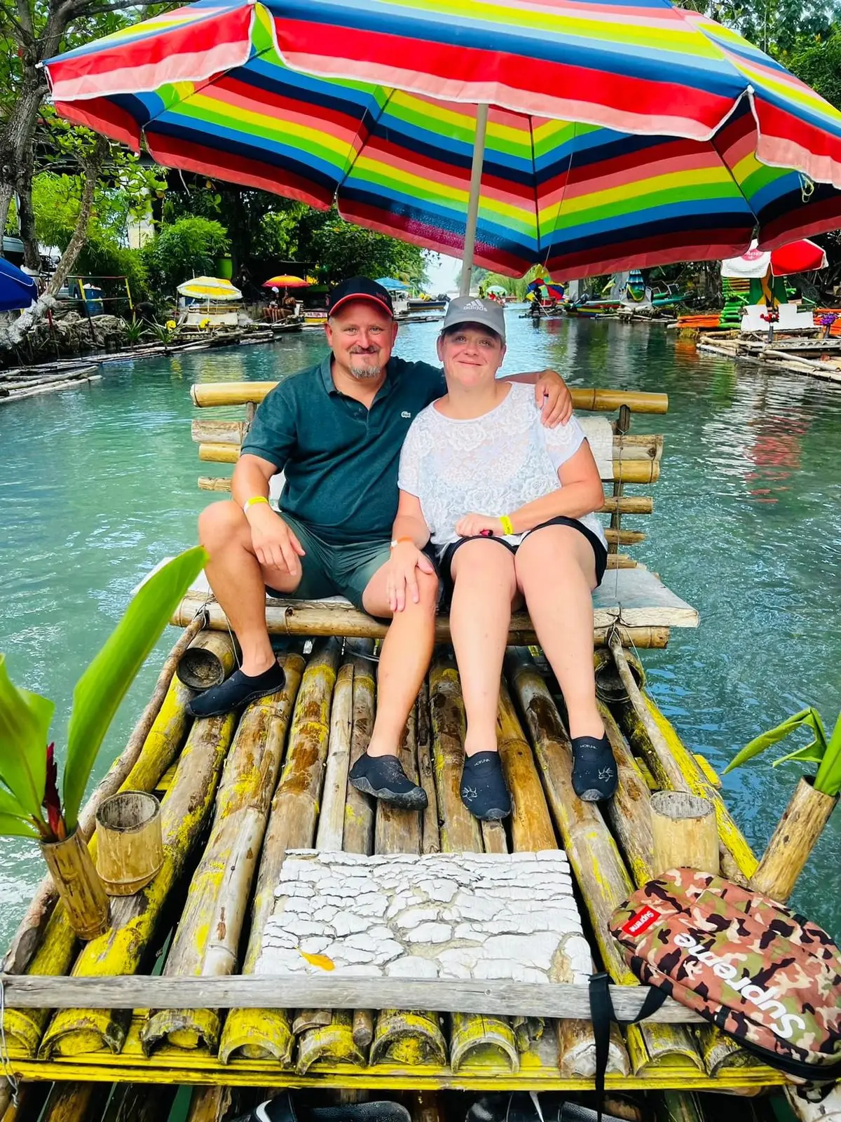 A couple relaxing on a bamboo raft during a Jamaica river tour